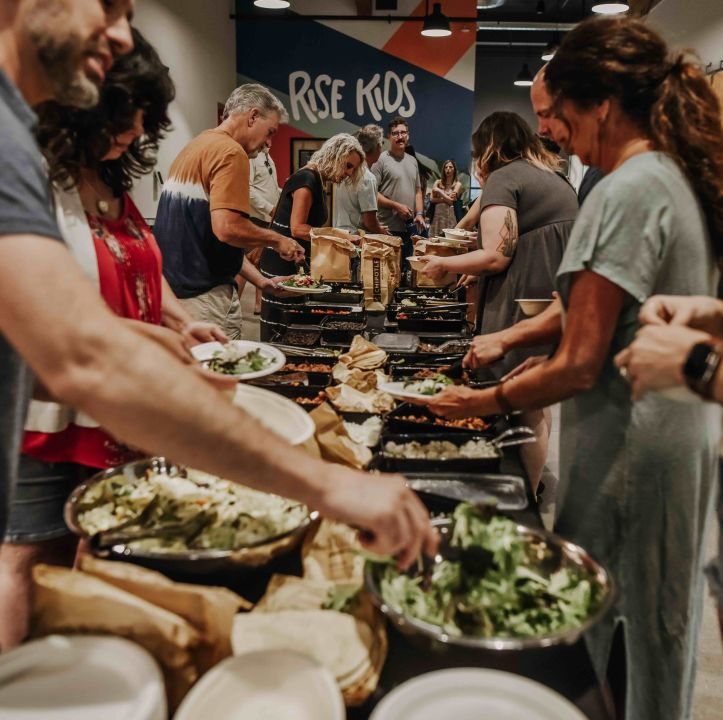 People sharing food together at Rise
